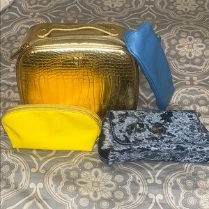 Cle de peau set of Gold, Yellow, Blue, and Black Bags